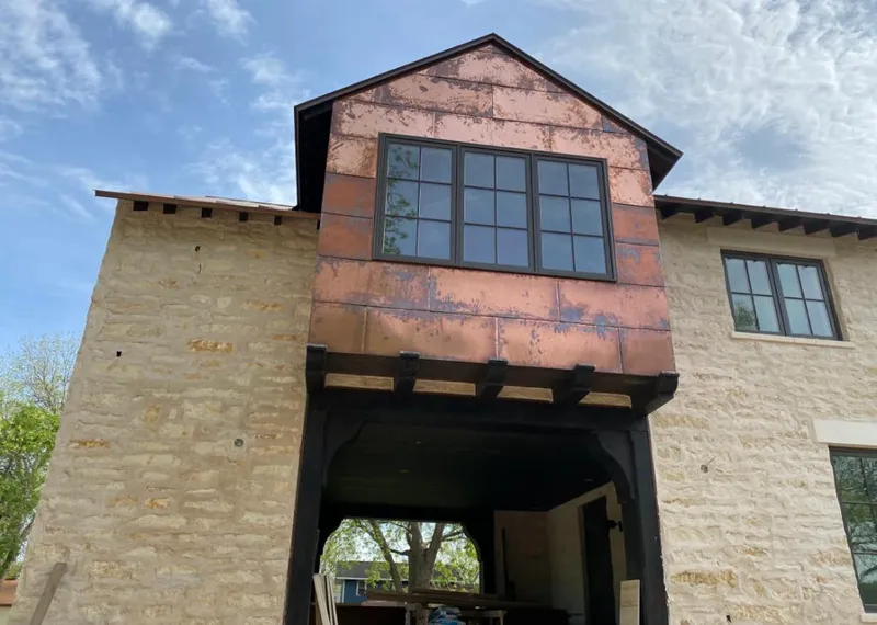 Copper metal panel facade on a stone building for Skylight Installation in Pitman